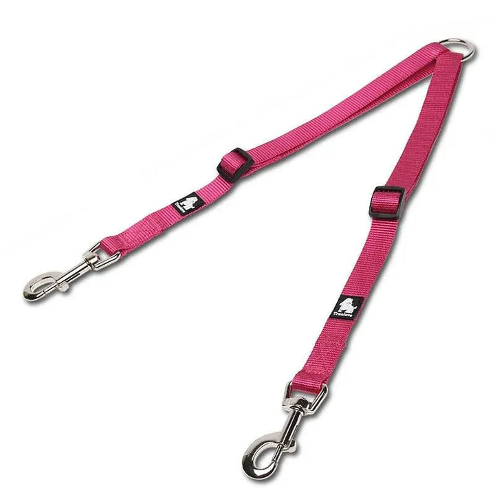 An image of a double dog leash with a tangle-free swivel mechanism. The leash features a soft, ergonomic foam handle and adjustable nylon straps in vibrant colors. Two sections of the leash branch out to allow walking two dogs simultaneously without tangling. Reflective stitching is visible for added safety in low-light conditions.