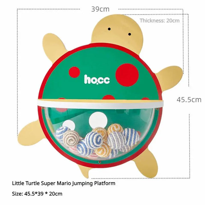 Cat jumping platform inspired by Super Mario, shaped like a turtle, with colorful accessories and a transparent acrylic dome filled with sisal rope balls.